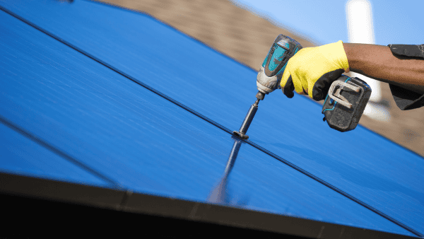 Worker Performing Maintenance On A Home Solar System
